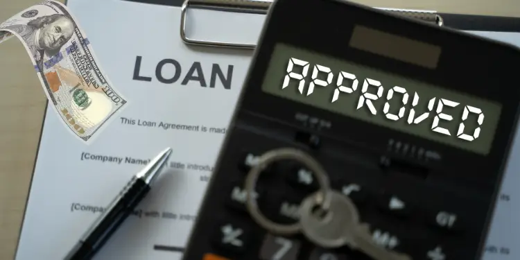 Loan agreement with approved calculator display and money.