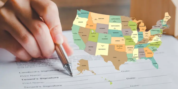 Person signing a rental agreement with a detailed map of U.S. states on top.