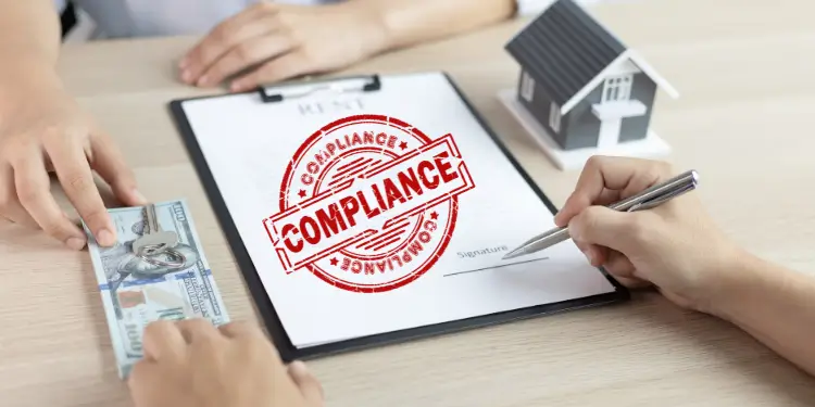 Close-up of hands exchanging cash and signing a lease with a compliance seal and house model.