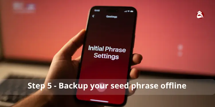 Hand holding a phone displaying Initial Phrase Settings for offline backup.