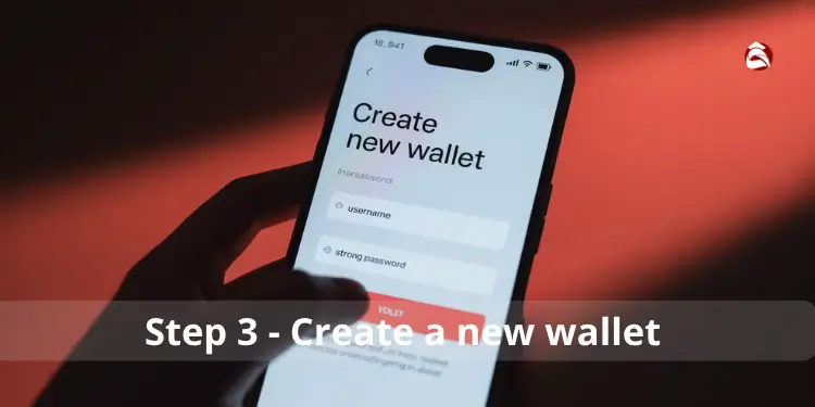 Hand holding phone with Create new wallet screen showing username and password fields