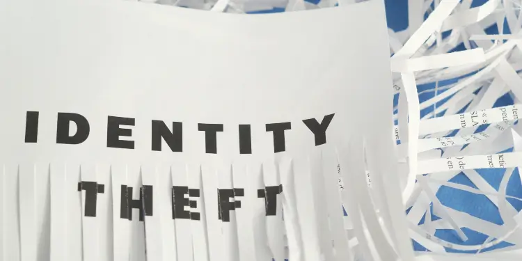 Identity theft document being shredded to symbolize personal data protection.