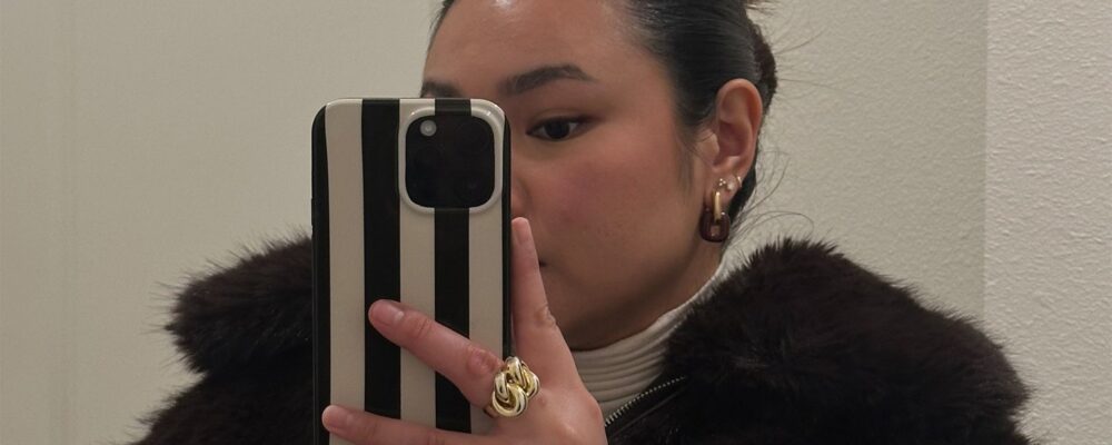 marina takes mirror selfie while wearing faux fur jacket
