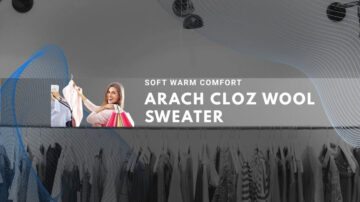 Woman shopping for Arach Cloz wool-blend sweater among hanging winter clothes in a boutique.
