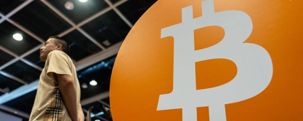 Bitcoin Rises to a Record as ‘Debasement’ Trade Spurs Risk Rally