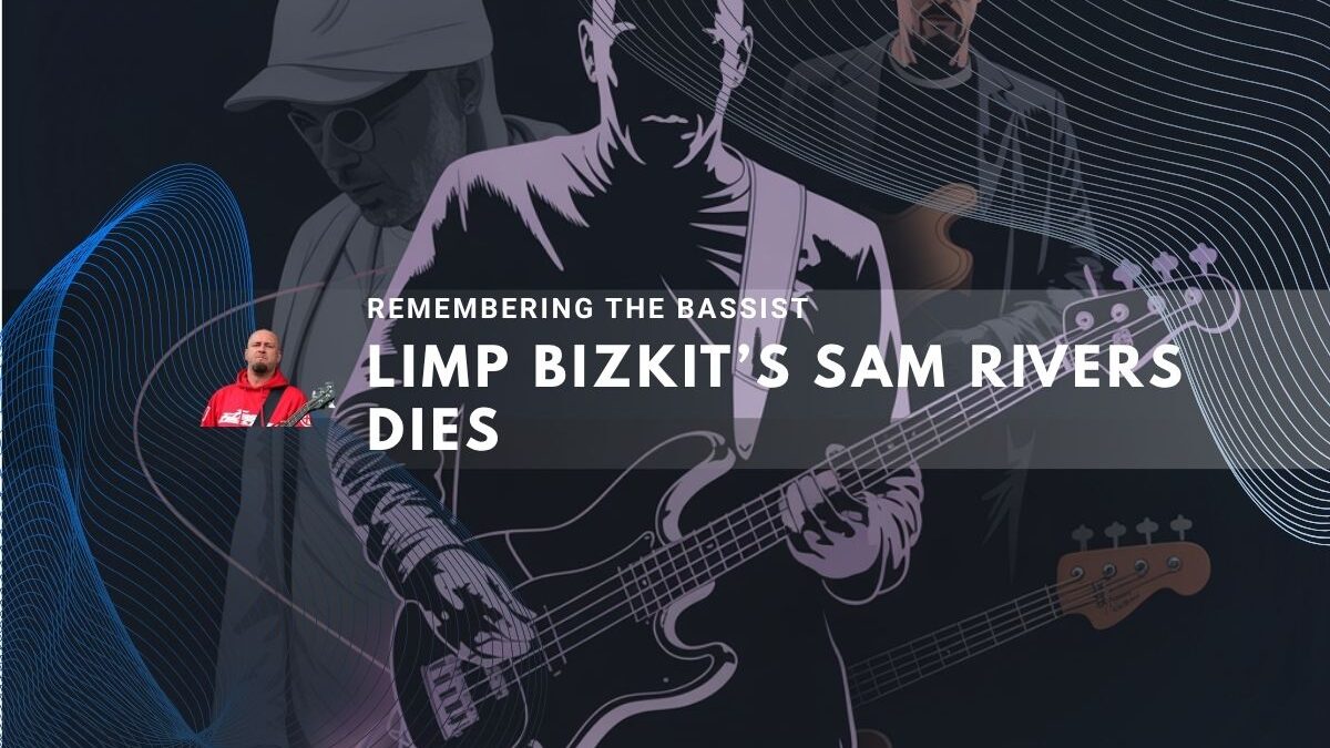 Sam Rivers playing bass guitar under dark lighting.