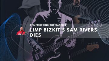 Sam Rivers playing bass guitar under dark lighting.