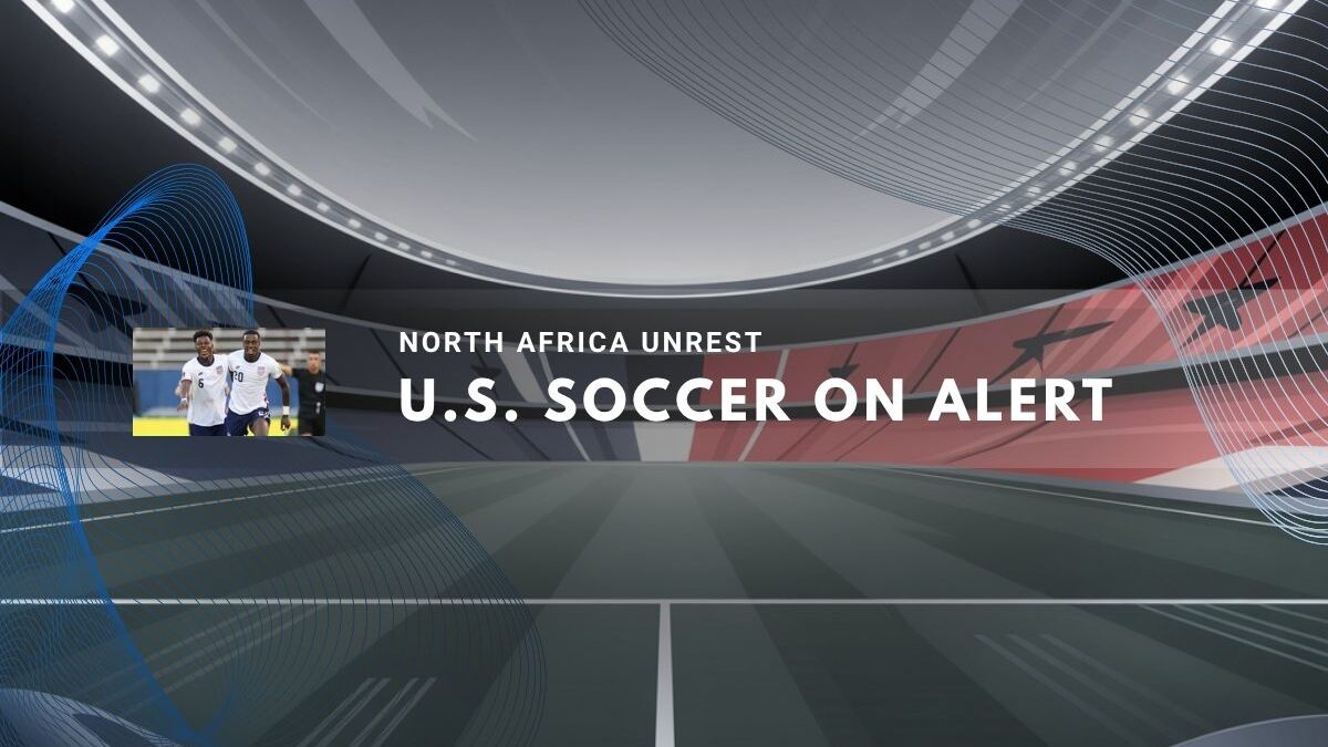 U.S. soccer players on field amid tense international atmosphere.