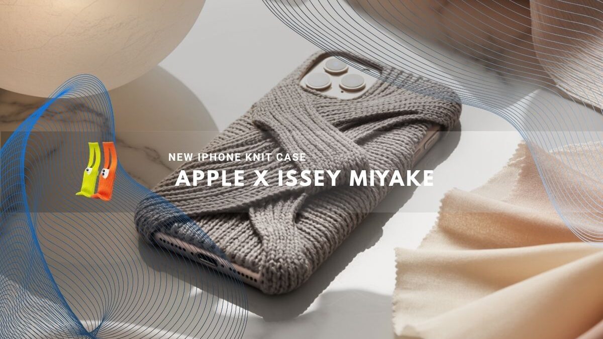 iPhone with a gray knit fabric case beside soft neutral textiles.