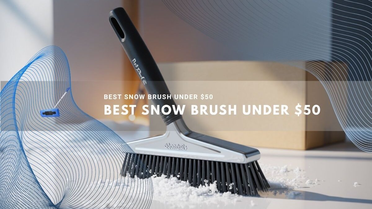 Close-up of a sleek black snow brush resting on a white surface