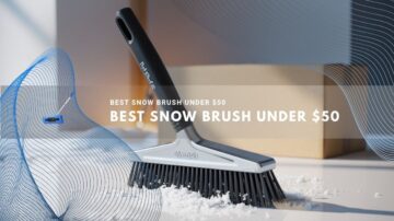 Close-up of a sleek black snow brush resting on a white surface