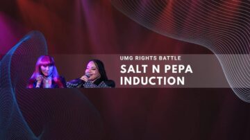 Salt N Pepa members on stage during induction ceremony with colorful lighting effects.